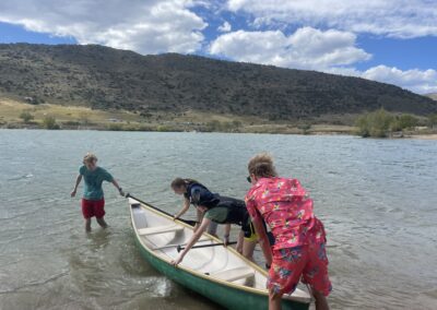 team members practicing with a real canoe in a lake