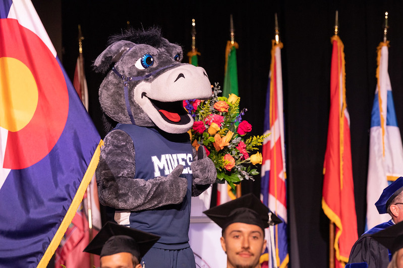 Blaster carrying flowers at commencement